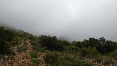 4k-Wide-shot-up-on-a-mountain-with-a-lot-of-clouds-and-fog-at-La-Concha,-near-Marbella,-Spain
