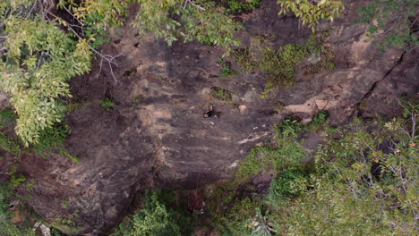 Female-rock-climber-ascending-as-drone-drop-from-above-insane-view