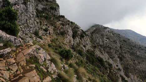 4k-Moving-shot-of-hikers-walking-up-on-top-of-mountain-side-in-Spain