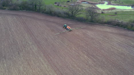 a-tractor-spraying-fertilizer-on-a-field
