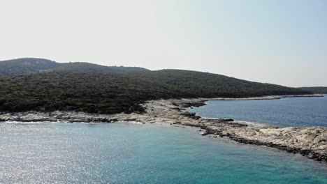Flying-Over-Scenic-Beach-At-Paralia-Emplisi-In-Greece---aerial-drone-shot