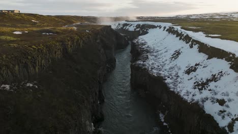 Hvita-River-Flowing-through-Cliffs-towards-Gullfoss-Falls-in-Iceland,-Aerial
