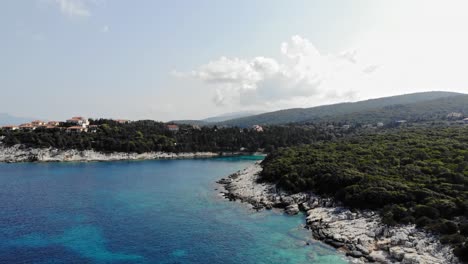 Lush-Vegetation-And-Turquoise-Ocean-Of-Paralia-Emplisi-In-Greece---aerial-drone-shot