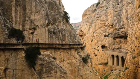 4k-Wide-shot-of-a-trail-on-the-side-of-a-mountain-cliff-at-El-Caminito-del-Rey-in-Gorge-Chorro,-Malaga-province,-Spain