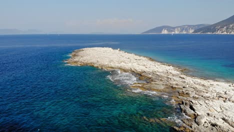 Rocky-Coast-And-Turquoise-Ocean-At-Paralia-Emplisi-In-Greece---aerial-drone-shot