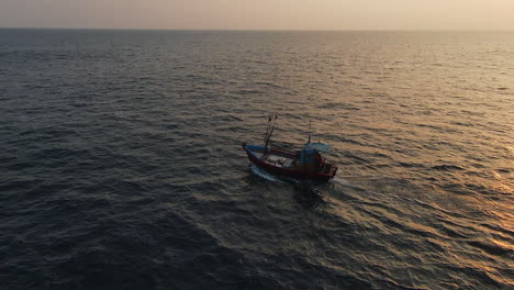 FPV-Orbit-Shot-Of-Small-Boat-Sailing-In-Blue-Ocean-With-Beautiful-Sun-Reflection,-Sri-Lanka