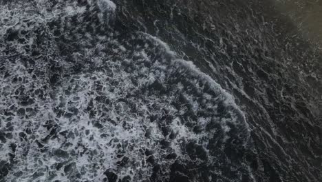 A-bird's-eye-view-footage-of-the-open-waters-with-various-waves-and-sea-foam