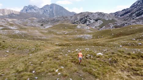 Man-Walks-at-Durmitor-National-Park,-Montenegro---Aerial-Dolly-Follow