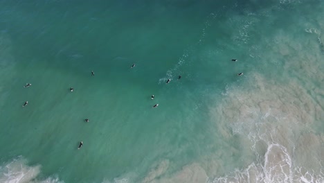 A-stationary-birdseye-view-of-wave-surfers-on-the-open-sea-while-bravely-facing-the-huge-waves-coming-towards-them