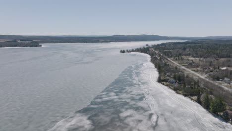 Quiet-Winter-Scenery-of-Lake-Magog-In-Alberta,-Canada---aerial-shot