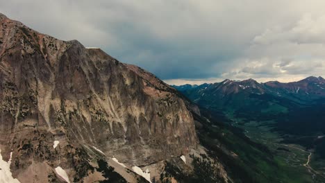 Drone-Footage-Of-Rocky-Mountain-Next-To-Deep-Long-Alpine-Valley
