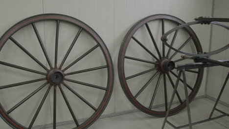 Large-old-carriage-wheels-standing-in-a-modern-workshop