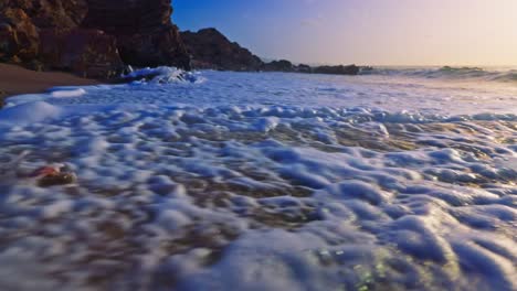 Slow-motion-shot-of-sea-waves-crashing-on-sandy-beach