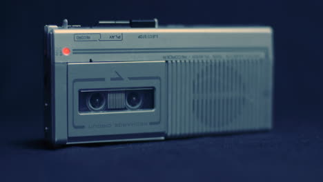 Tilt-Up-To-Full-Shot-Of-Microcassette-Recorder-In-Cold-Lighting