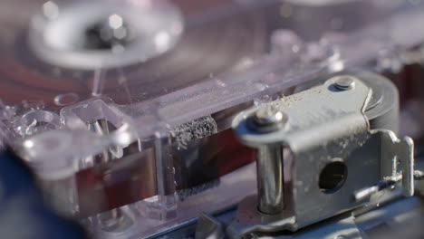 Close-Up-Of-Microcassette-Recorder-Tape-Ribbon-Running-Through-Cassette