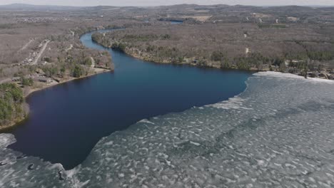 Ice-Sheets-Floating-In-The-Calm-Waters-Of-Lake-Magog-With-Stream