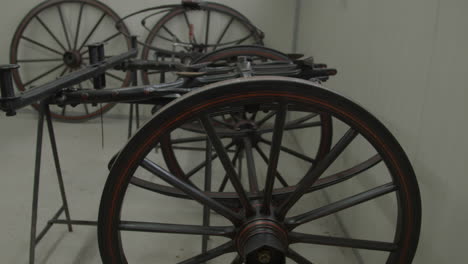 Tilt-up-of-large-wheels-and-under-carry-of-old-carriage-under-restoration-in-workshop