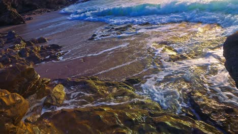High-angle-slow-motion-ocean-waves-at-a-rocky-beach
