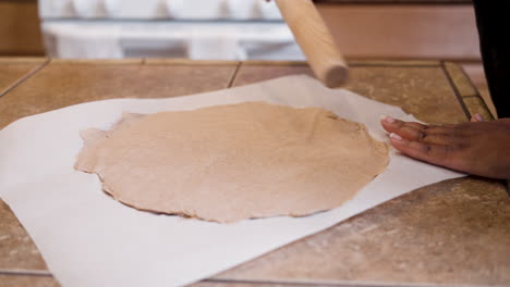 Rolling-our-dough-on-wax-paper-to-make-Passover-bread