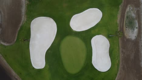 Drone-video-of-a-golf-course-hole-surrounded-by-sand-traps