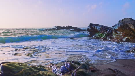 Ocean-waves-crashing-on-a-sandy-and-rocky-beach
