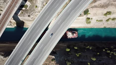 View-of-the-Corinth-Canal-and-a-boat,-with-highways-across-it
