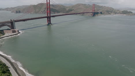Aerial-pan-up-of-water-and-Golden-Gate-Bridge-in-San-Francisco,-CA
