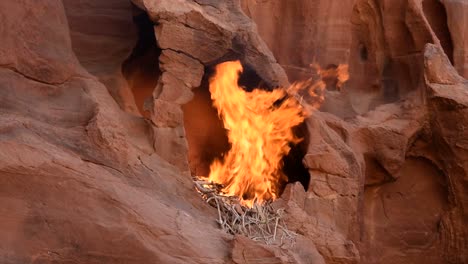 Large-fire-burning-in-a-rocky-cavity,-Wadi-Rum-Desert