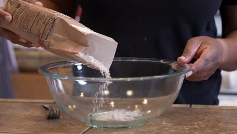Adding-flour-to-a-mixing-bowl-to-make-Passover-bread---slow-motion