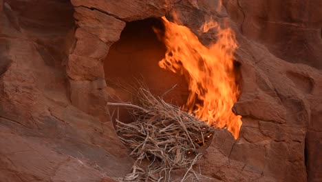 Fire-burning-in-a-brown-rock-cavity,-Wadi-Rum,-Jordania