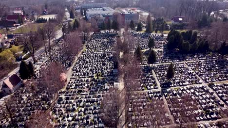 Aerial-shot-of-huge-modern-graveyard-with-shining-graves-on-sunny-morning