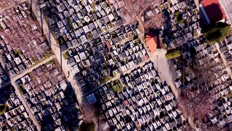 Bird-eye-view-of-cemetery-on-sunny-day,-drone-cinematic-shot