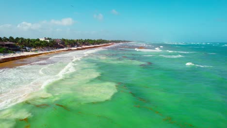 Drone-Aerial-Footage-Of-Tropical-Caribbean-Beach-Shore-During-High-Tide-in-Tulum,-Mexico