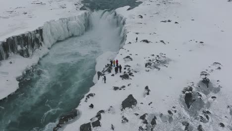 Photographer-Tourists-on-Snowy-Expedition-to-Dettifoss-Waterfall-in-Iceland---Aerial