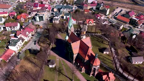 Aerial-shot-of-huge-old-church-located-in-the-small-town