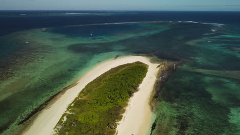 Slow-aerial-zoom-out-above-tiny-island-near-Isle-of-Pines,-New-Caledonia