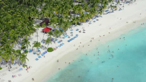 Hanging-out-on-the-most-beautiful-beach-in-the-Caribbean,-Saona,-Dominican-Republic,-aerial-orbit