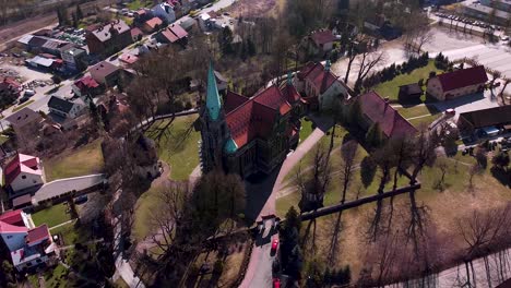Aerial-shot-of-huge-old-church-located-in-the-small-town