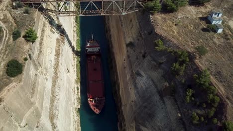 View-of-a-red-boat-in-the-Corinth-canal,-Greece