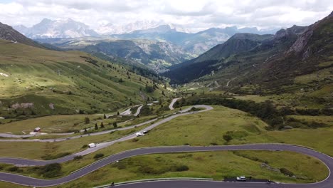 Pordoi-Mountain-Pass-at-Trentino,-South-Tyrol,-Dolomites,-Italy---Aerial-Drone-View-of-the-Hairpin-Curves-and-Green-Valley-in-the-Italian-Alps