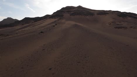 Aerial-drone-ascending-on-top-mountain-near-Zagora-in-Morocco-desert