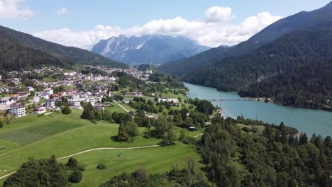 Lago-di-Centro-Cadore-Lake,-Belluno,-Dolomites,-Italy---Aerial-Drone-View-Vallesella-Town,-Blue-Water-Reservoir,-Green-Valley-and-High-Mountains