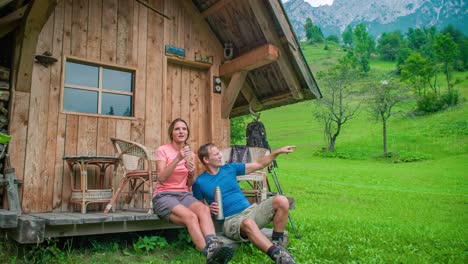 Married-Couple-Relaxing-And-Admiring-Nature-At-Log-Cabin
