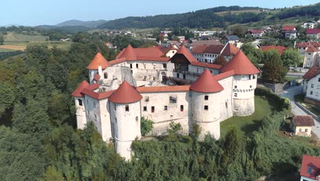Fly-over-drone-shot-of-Zuzemberk-Castle-on-a-sunny-day