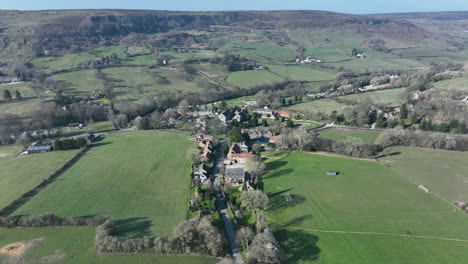 Rosedale-Abbey-village,-Aerial-Footage,-North-York-Moors-National-Park,-Push-forward-over-village-pan-down
