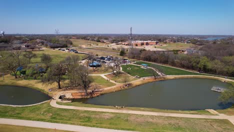 Aerial-footage-approaching-Unity-park-in-Highland-Village-Texas-and-flying-over-two-ponds