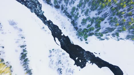 Rise-And-Spin-Above-Powerful-River-Among-Snowbound-Valley-And-Forests