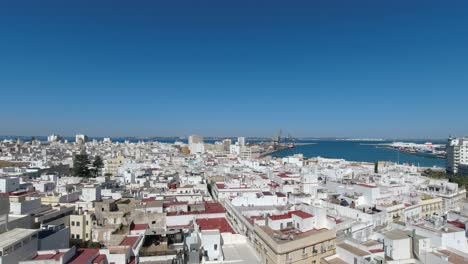 Pan-over-whitewashed-houses-of-Cadiz-city-from-high-above-viewpoint
