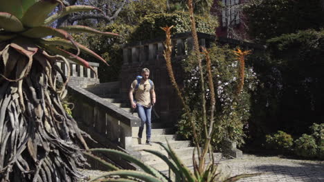 Backpackers-walking-downstair-outdoor-in-scenic-stairway-down-to-natural-green-botanic-garden-in-the-city-in-porto-Portugal