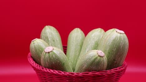 Rotating-fresh-zucchini-isolated-on-red-background.-Close-up